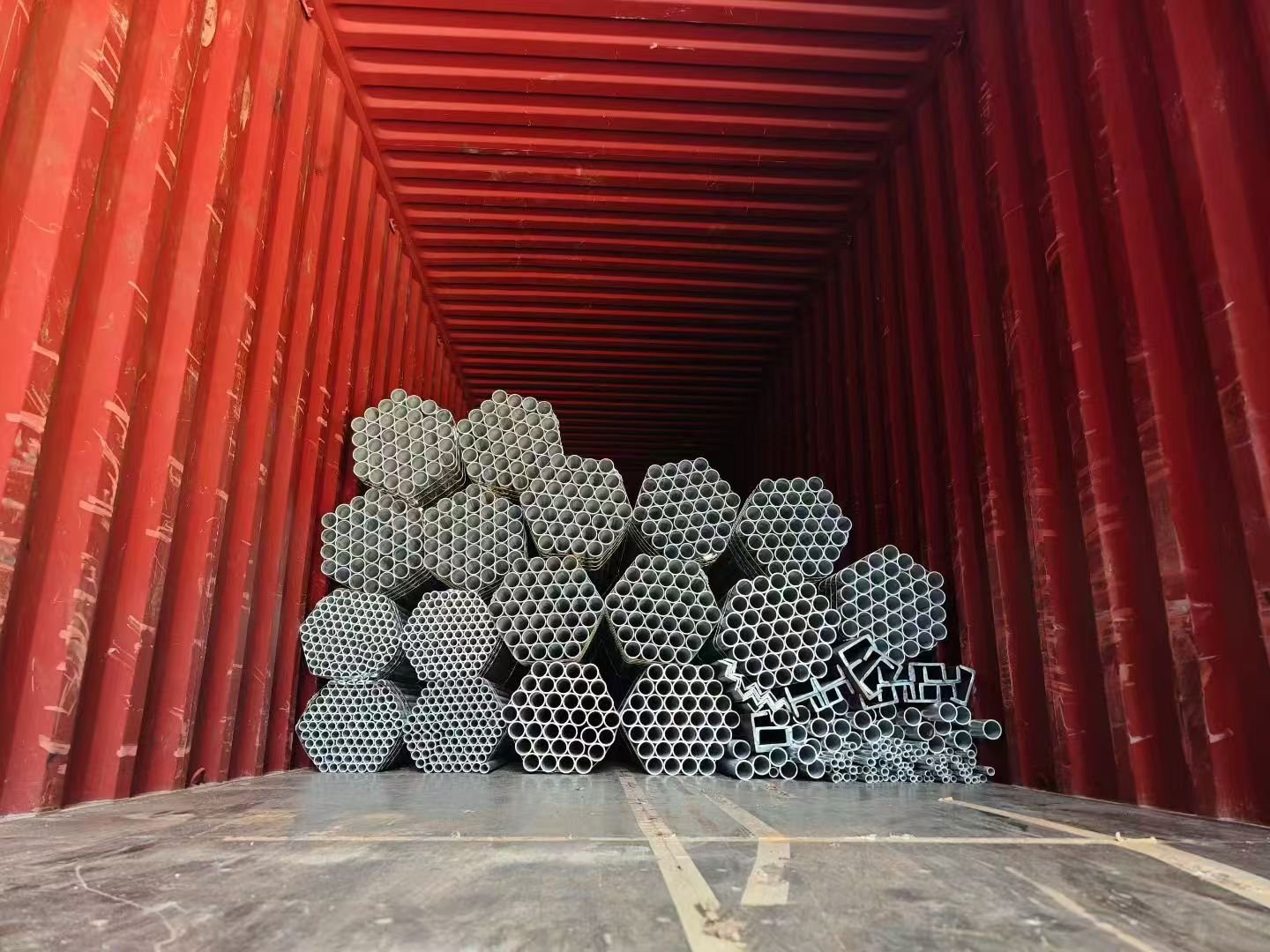 Galvanized steel pipes loaded inside shipping container for export, bulk steel pipe shipment from China