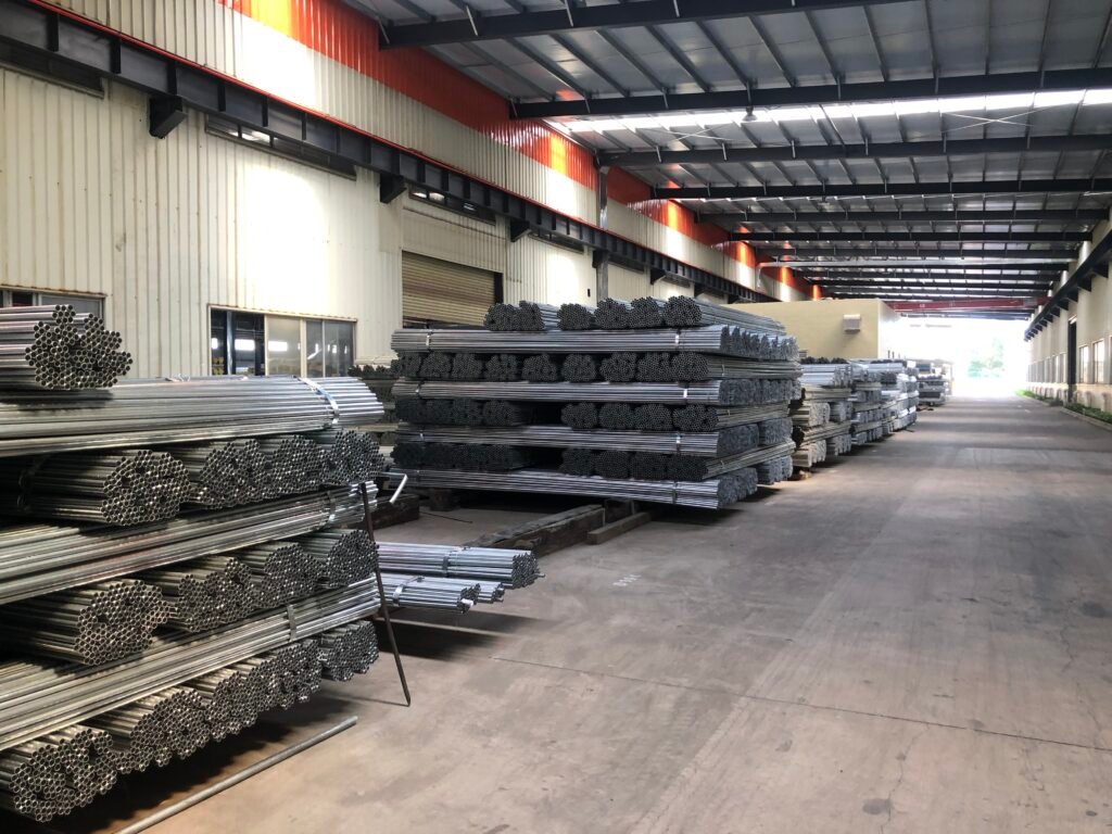 Galvanized steel electrical conduit pipes stored in factory warehouse