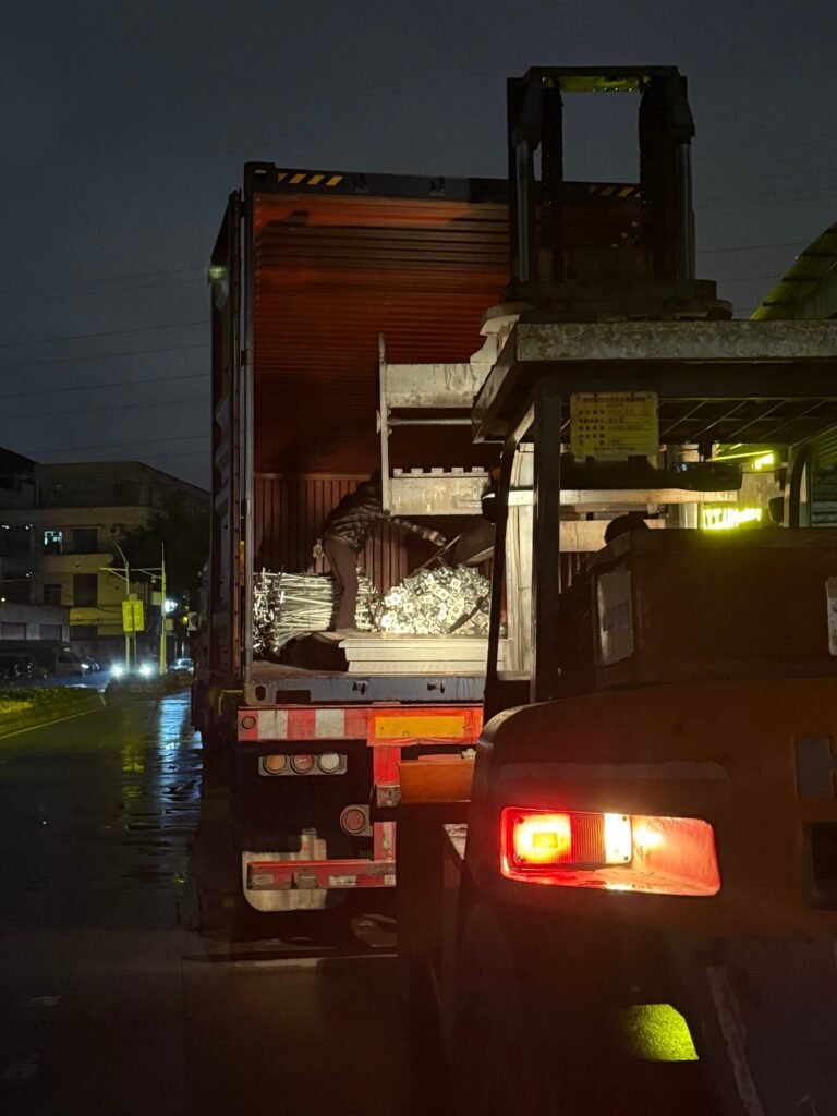 Container truck loaded with steel at night