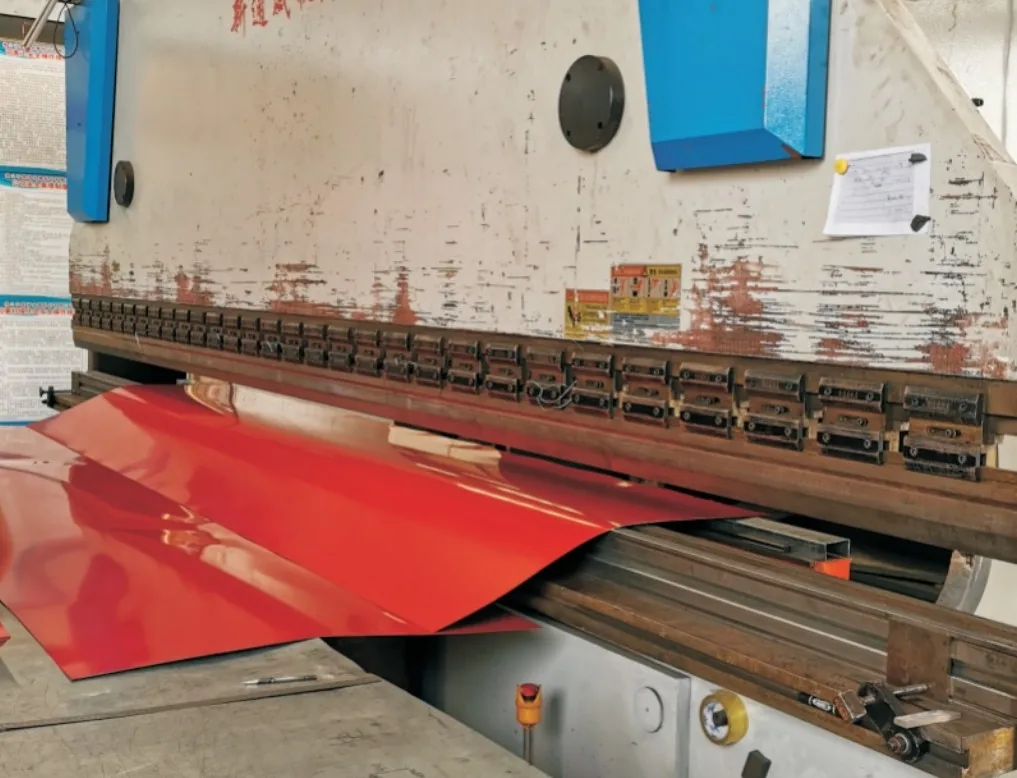 CNC press brake bending a color-coated steel sheet